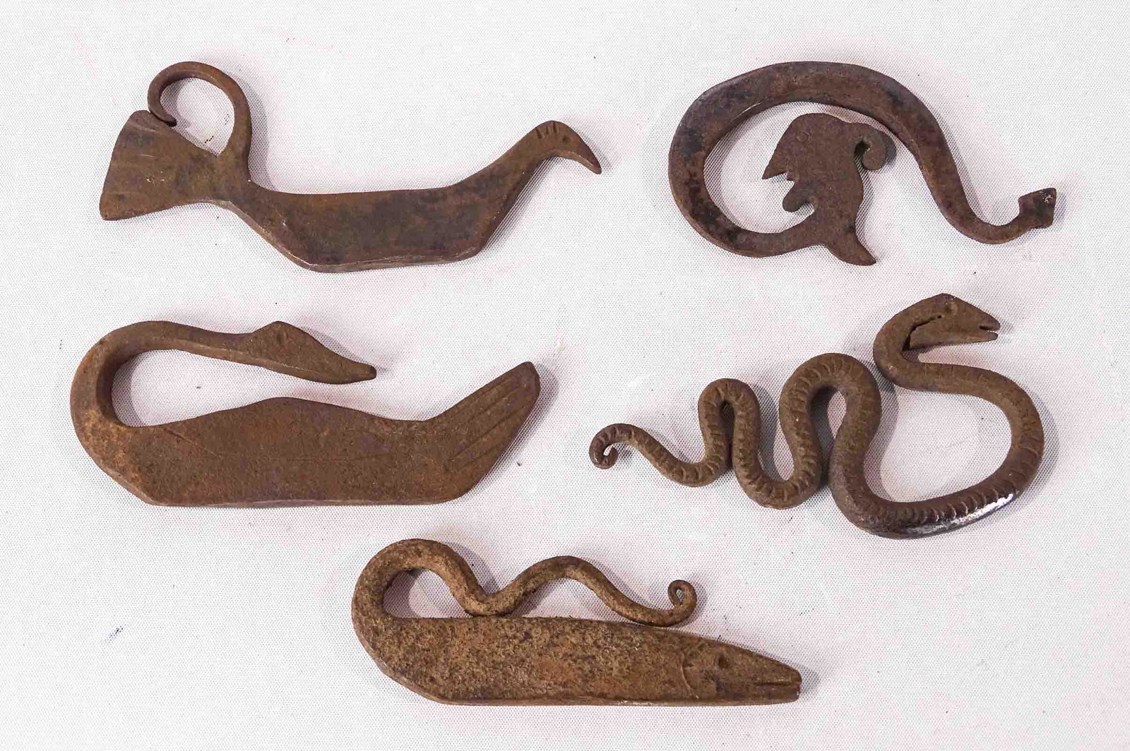 Figural Flint Strikers: Lot (5) iron figural flint strikers. Largest 4 1/2" L..