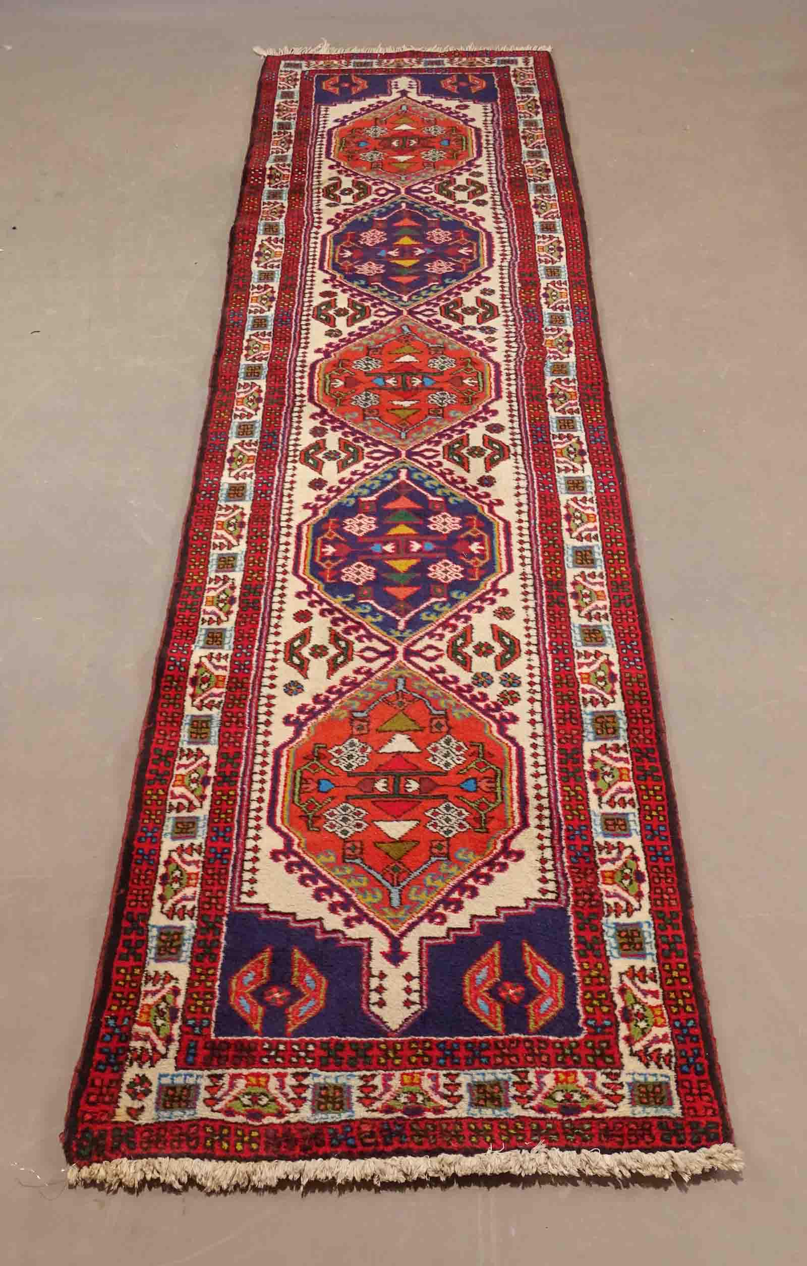 Oriental Rug: Oriental rug. 9' 9" x 2' 4". Property of The Barbara Packer, Estate, Germantown N.Y. and N.Y.C..