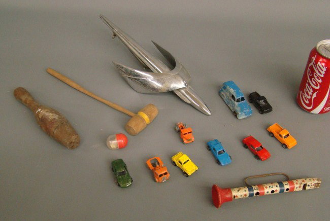 Toy Lot: Toy and hood ornament lot including Rocket Ship car hood ornament marked "M8-16850", Tootsietoy and Lesney cars, patriotic tin horn marked "Made In United States Of America".