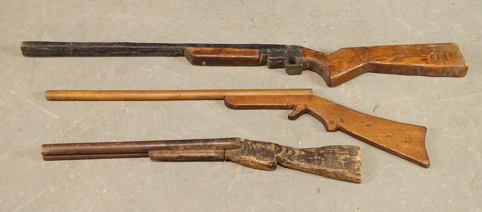 Folk Art Wooden Rifles: Lot (3) folk art wooden rifles. Largest 41" L..