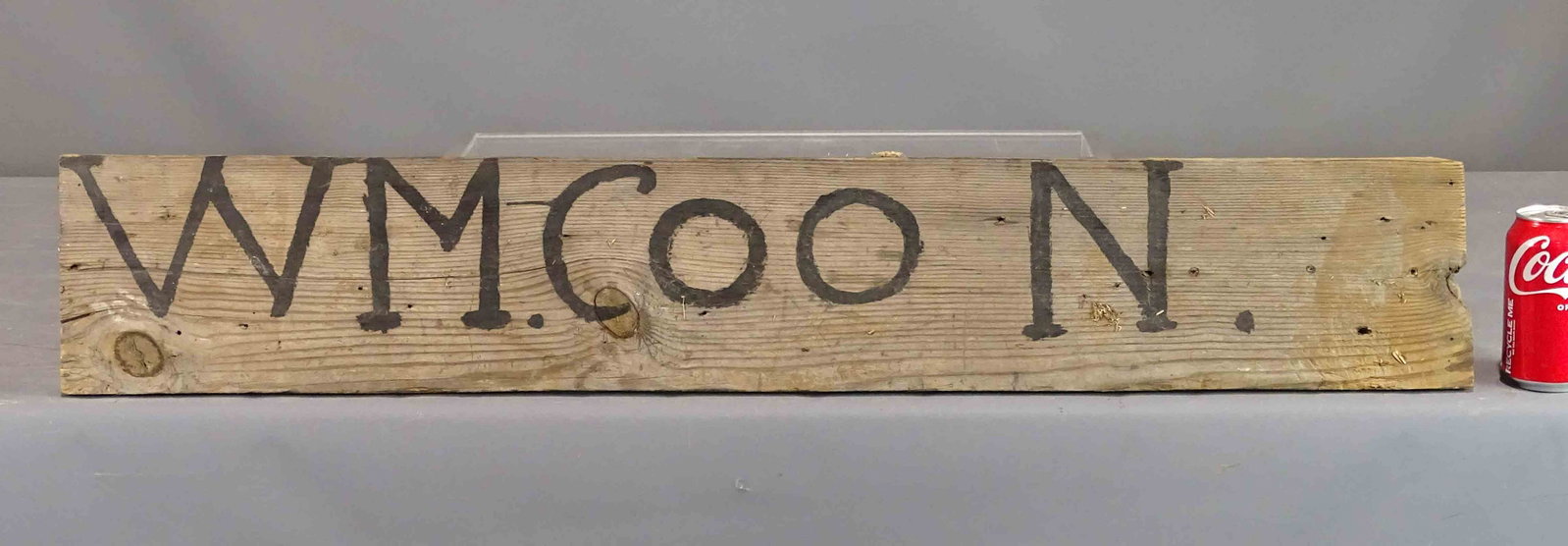 Sign: Early primitive sign "WM COON". 6 1/2" x 39".