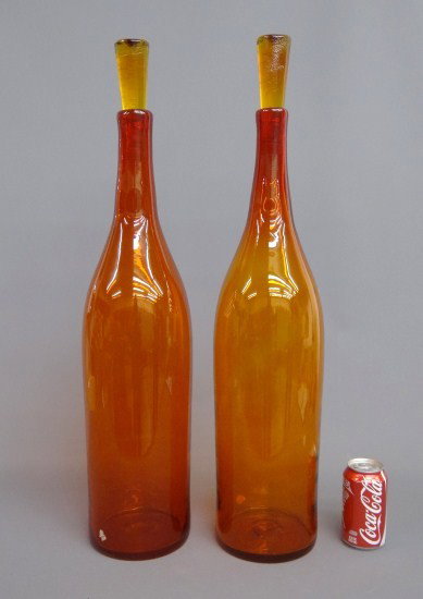 Pair Mid Century Blekno Handcraft Bottles: Pair labeled "Blenko Handcraft" bottles with stoppers. 29" Ht.