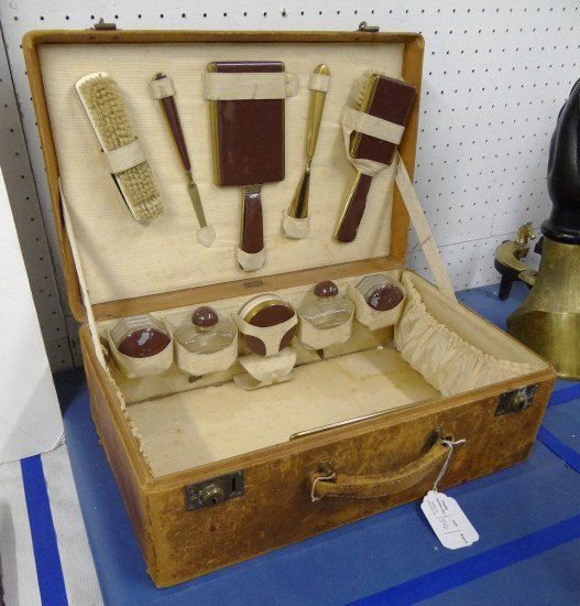 Vintage Suitcase: Vintage leather suitcase with various toiletries. Labeled "Boyle".