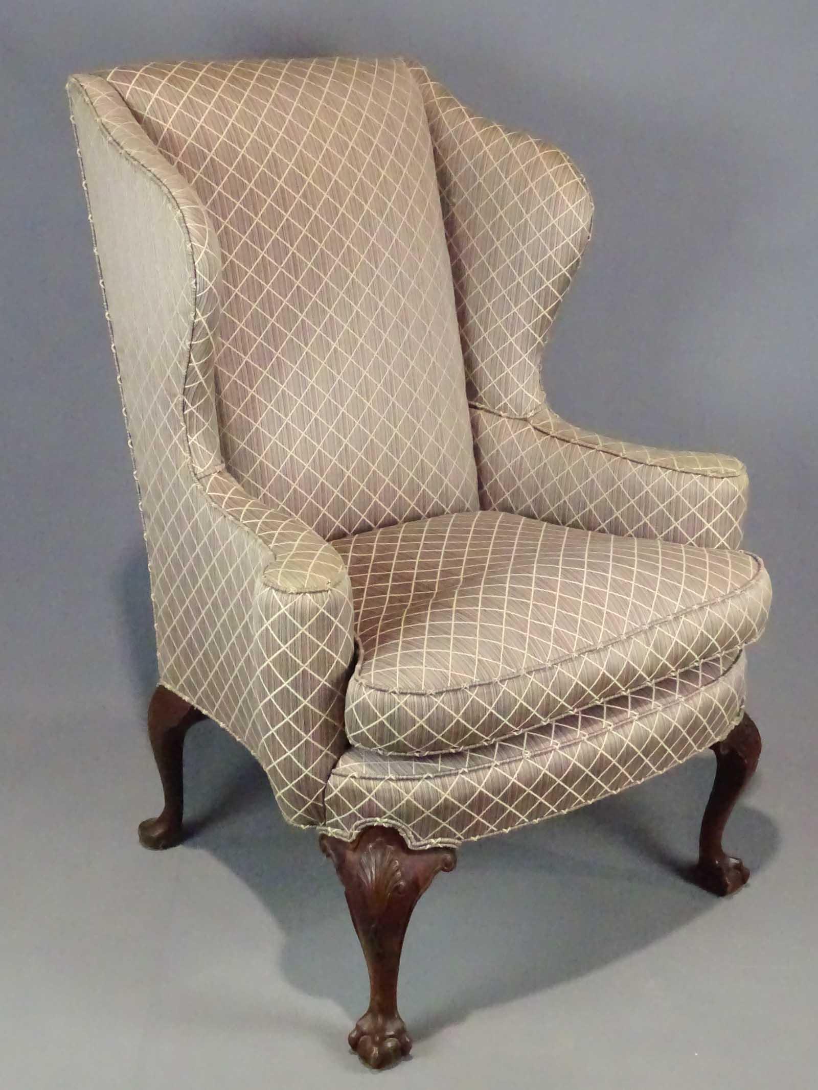 Wing Chair: 20th Century Chippendale style wing chair with ball and claw carved feet. 21" seat Ht., 44" overall Ht..