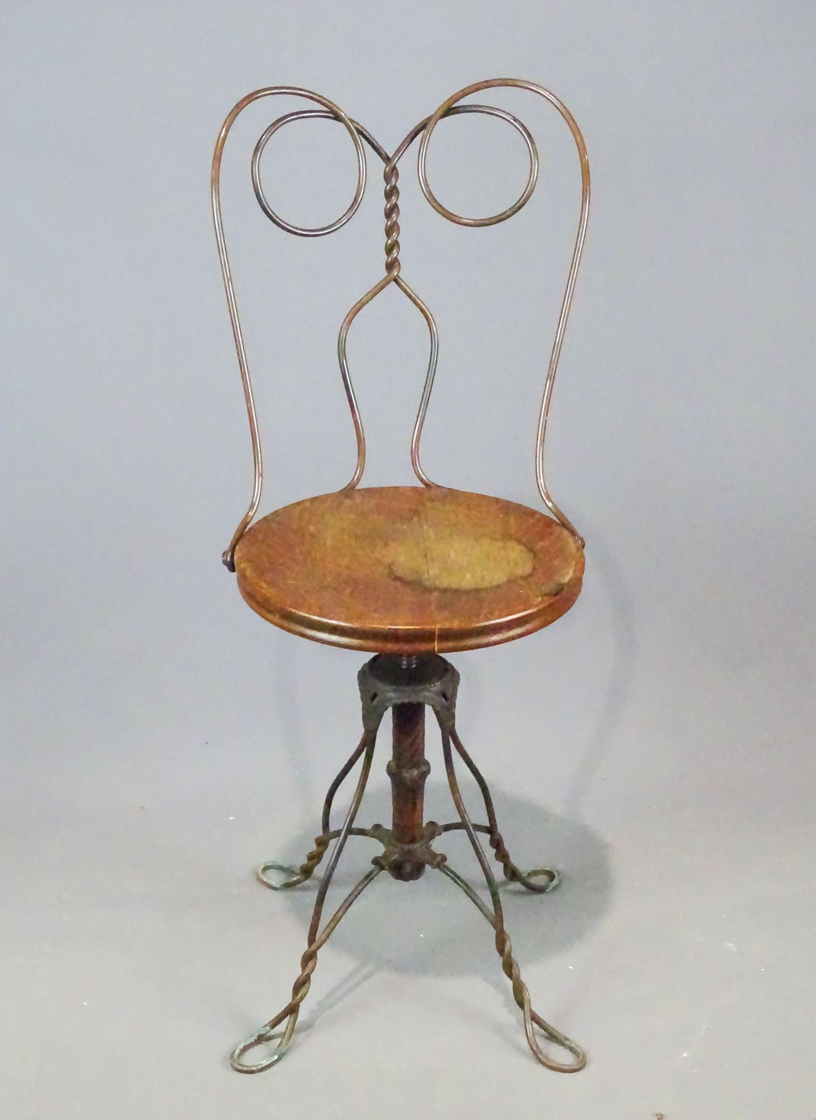 Iron Revolving Chair: Iron oak seat revolving chair. 21" seat Ht., 37" overall Ht..