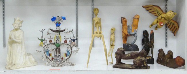 Ethnic Lot: Misc. lot including erotic carvings, South American pottery group, skeleton carvings and plaster religious figure. Some damage.