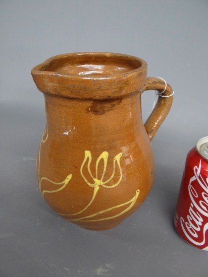 Redware Pitcher: Redware slip decorated pitcher. 8" Ht.