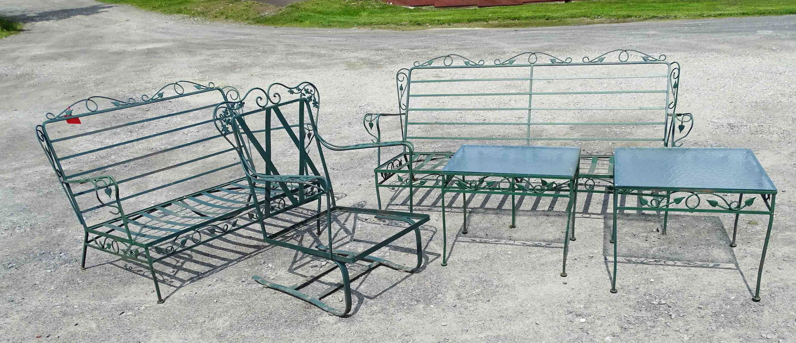 5 Pieces Patio Furniture: Misc. (5) piece wrought iron patio furniture: (2) settees 51" x 71"; arm chair; (2) glass top tables. No cushions.