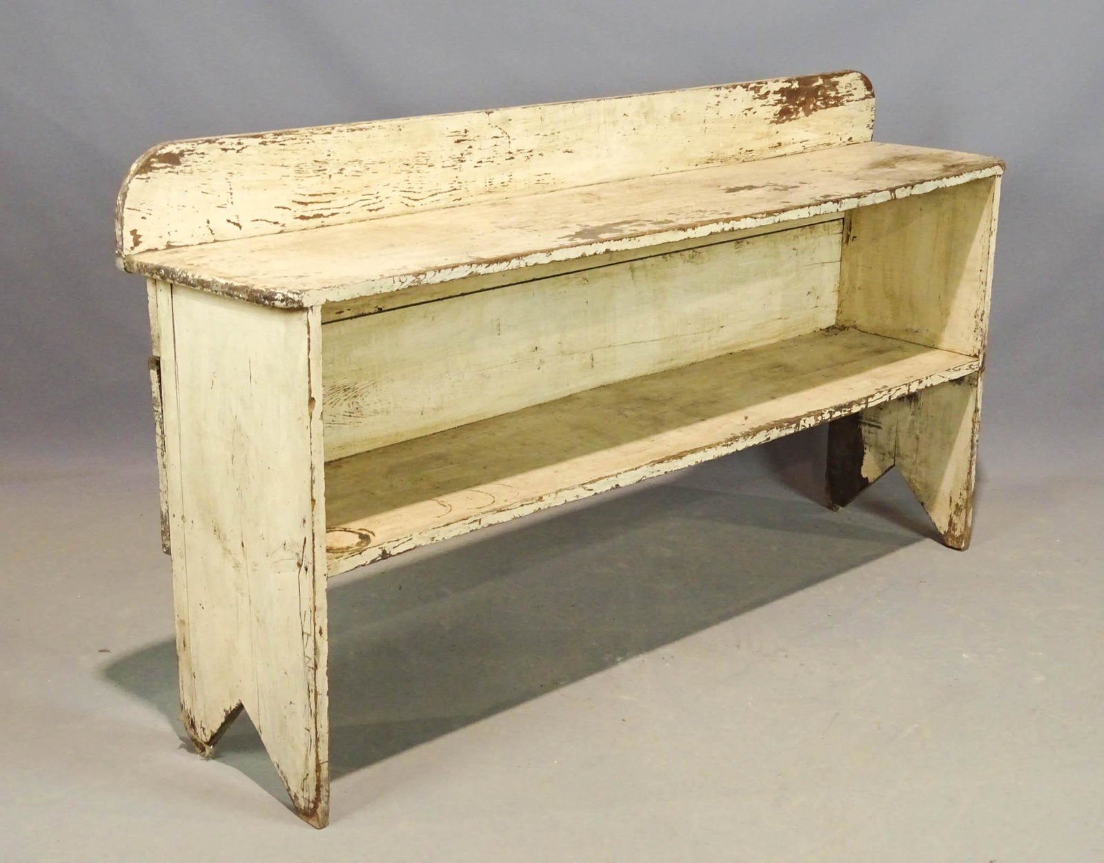 19th c. Bucket Bench: 19th c. primitive bucket bench with bootjack ends and splash back, old bone white paint surface. 60 1/2" W x 13" D. x 26 1/2" deck Ht., 32" overall Ht..