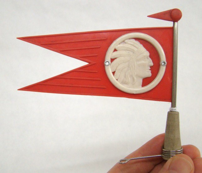 Indian Chief Flag: Front Fender or Stem Bolt mount accessory. Native American Indian Chief. Circa 1935. Marked "D. B. G. M." 5: wide x 4-1/2" tall. Near Mint.