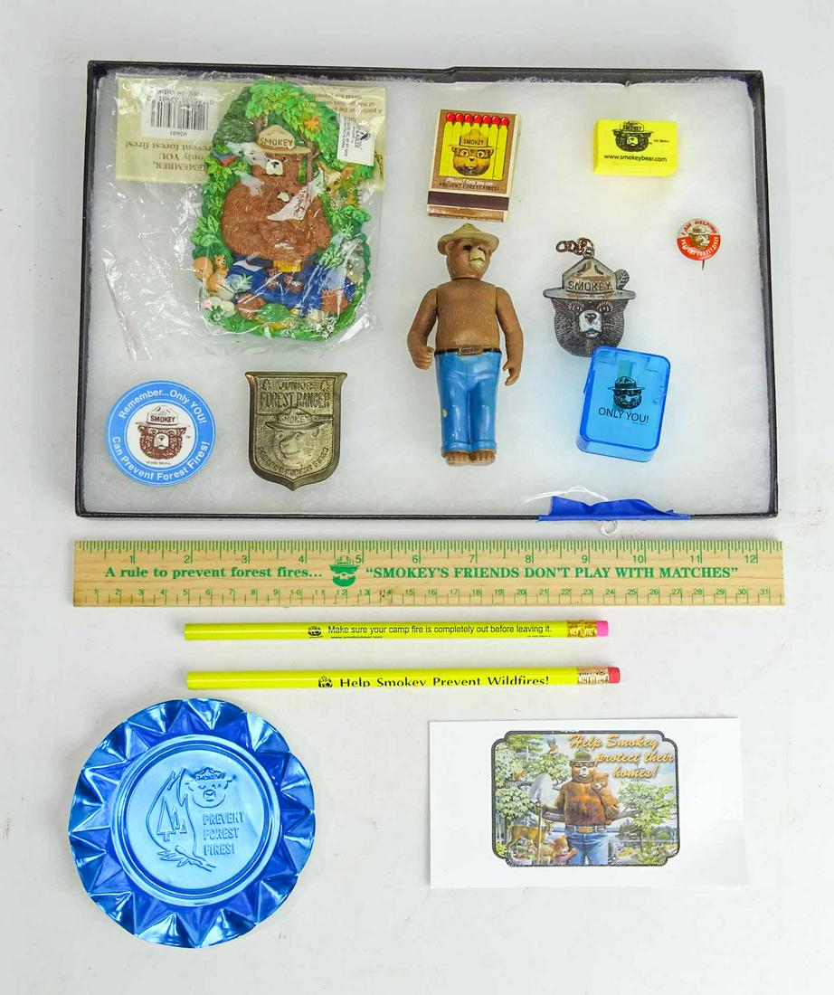 Smokey The Bear Lot: Showcase lot including (14) Smokey The Bear items. Case included.