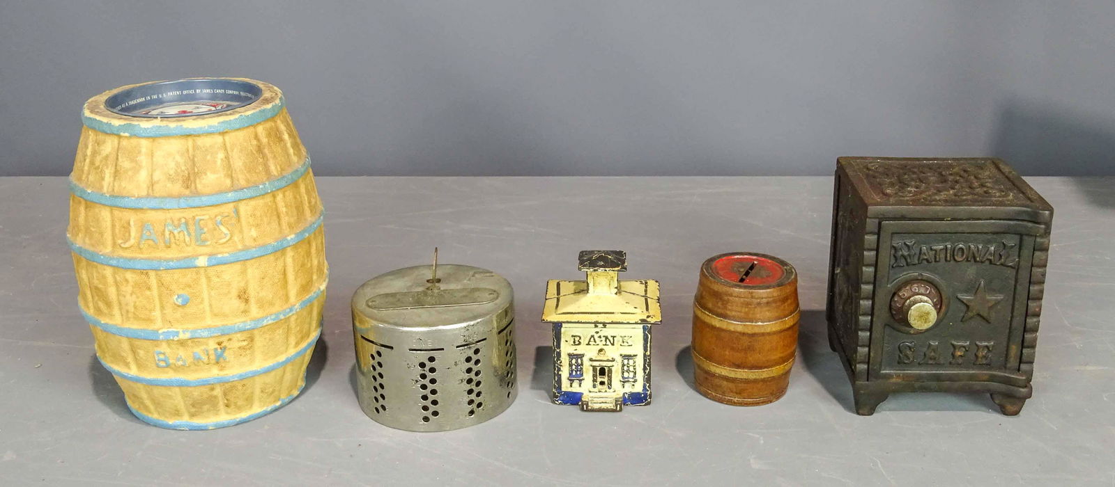 Bank Lot: Lot (5) still banks including cast iron cupola (3 1/2" Ht.), National Safe (5" Ht.), composition James bank (7 1/2" Ht.), wooden barrel and Citizen State Bank.