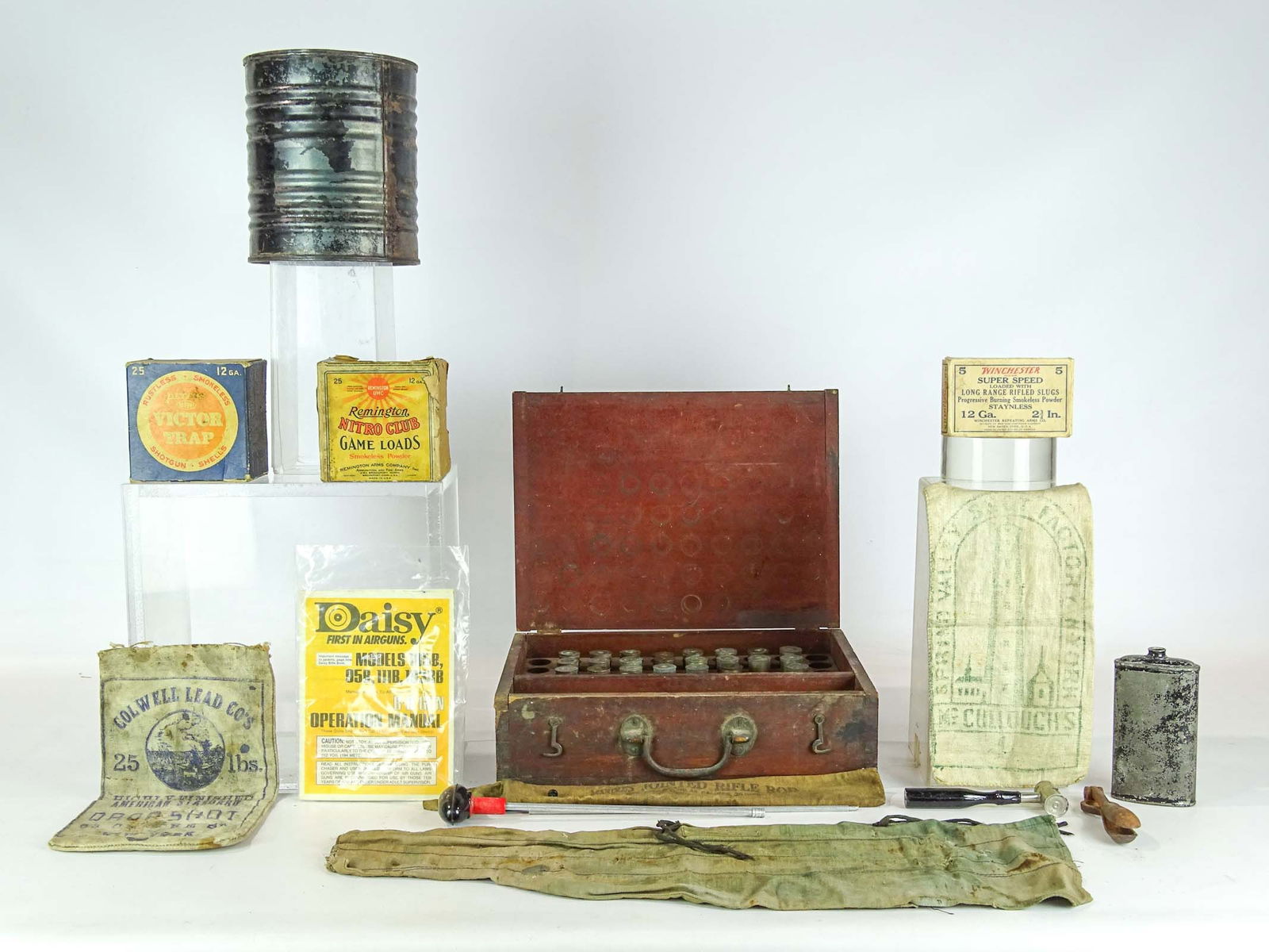 Misc. Lot: Lot including empty Remington, Victor Trap boxes, empty black powder key, Marbles Jointed Rifle Rod, empty Winchester box, Daisy manual, Winchester rod bag, (2) cloth shot bags, reload kit (empty shel
