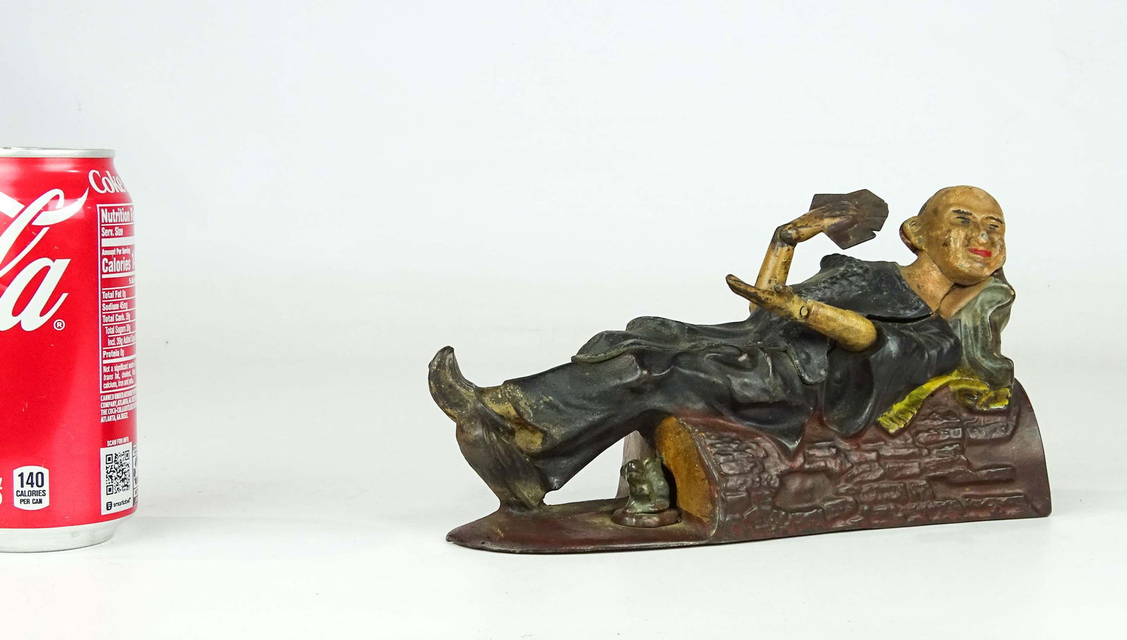 J & E Stevens Reclining Chinaman Bank: C. 1882 cast iron J & E Stevens Conn., "Reclining Chinaman" mechanical bank. 8" L..