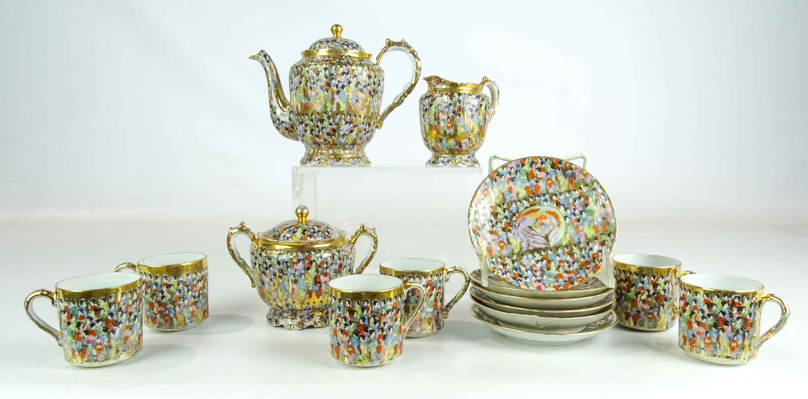 Tea Set: 1000 Faces tea set including 6" teapot, cream and sugar, (6) cups and saucers.