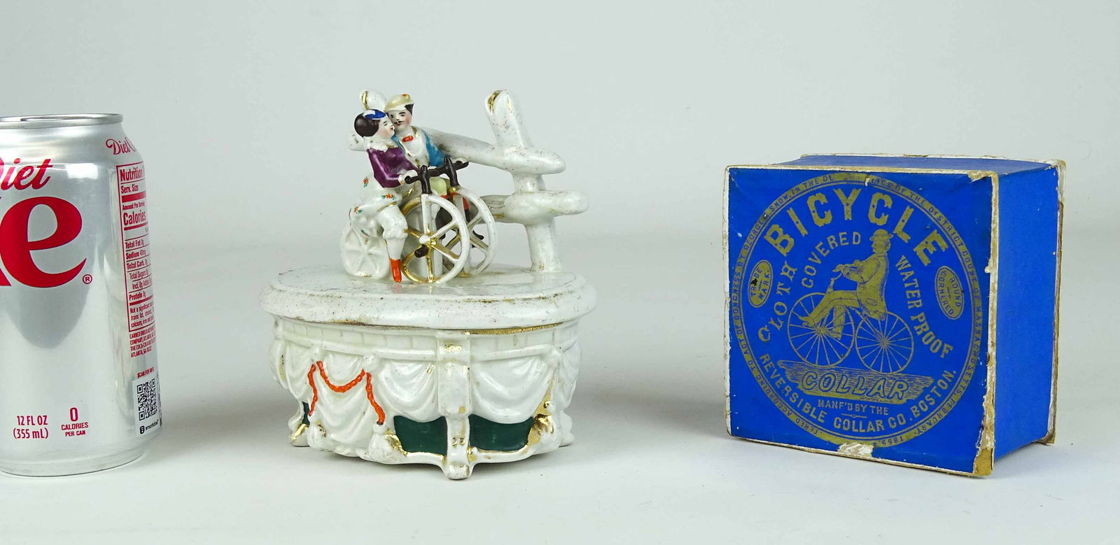 Misc. Lot: Lot including C. 1870 porcelain box with boneshaker riders on lid (good condition, 5" W.), and C. 1870 collar box (4" x 4" x 2 1/1", fair condition). Ed Berry Collection.