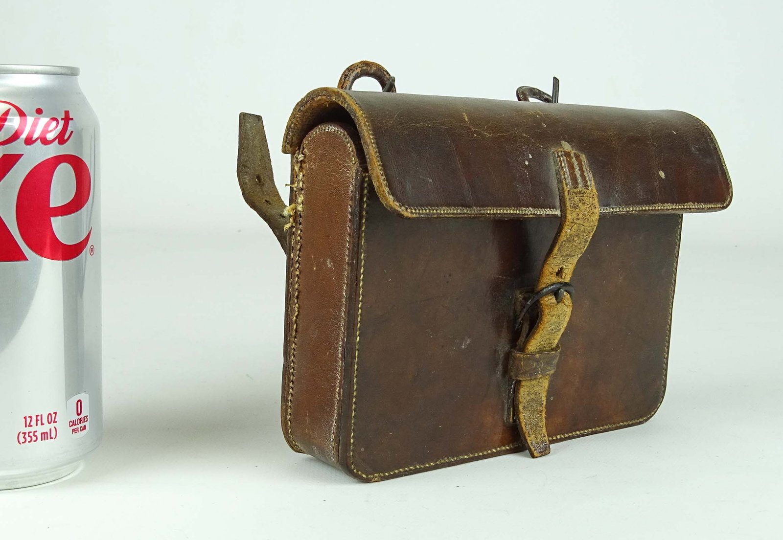 High Wheel Bicycle Accessory: Leather pouch with silverplate Norfolk & Norwich Bicycle Club container dated 1877. Pouch overall 6" x 4 1/2" x 1 1/2". Good condition. Ed Berry Collection.