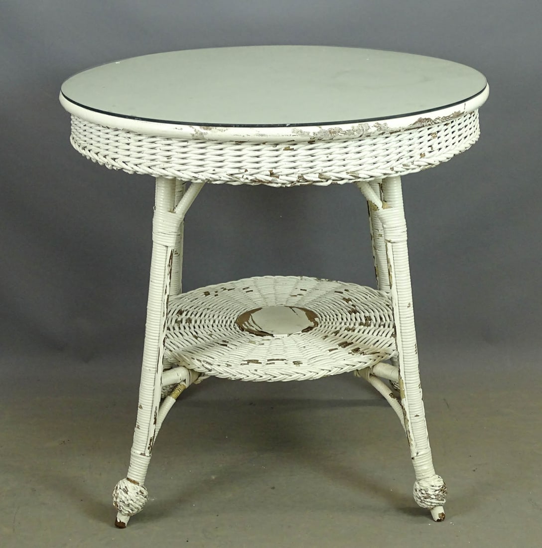 Wicker Table: Wicker table with glass top. 28" D., 29" Ht..