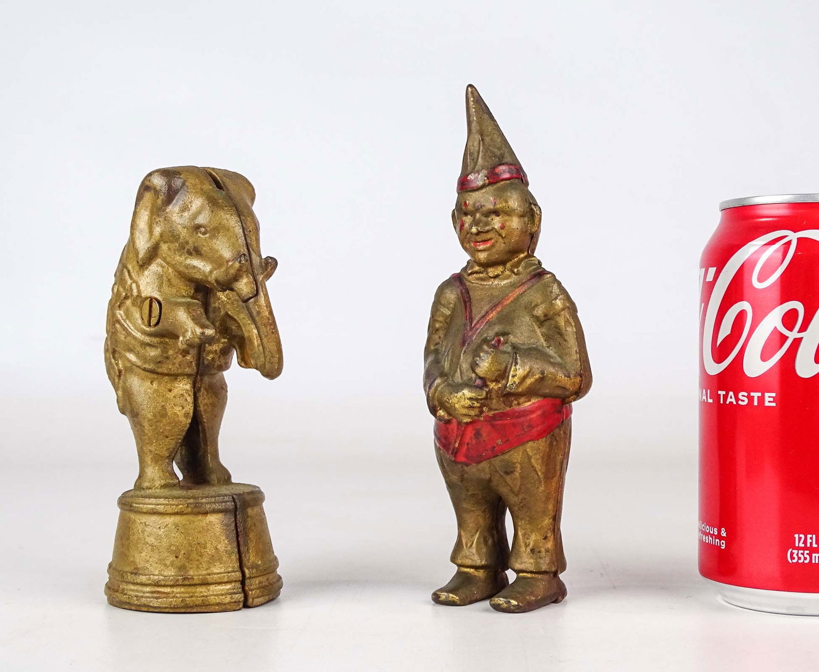 Bank Lot: Lot (2) cast iron still banks including Elephant on drum (5 1/2" Ht.), and Clown (6 1/2" Ht.).