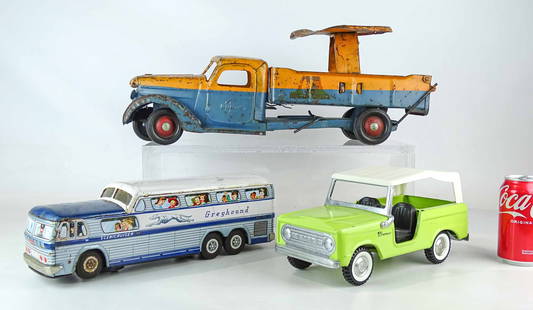 Toy Lot: Lot (3) toys including "GREYHOUND" bus (14" L.), Buddy L "RIDER DUMP TRUCK" (20" L.), Bronco (10 1/2" L.).