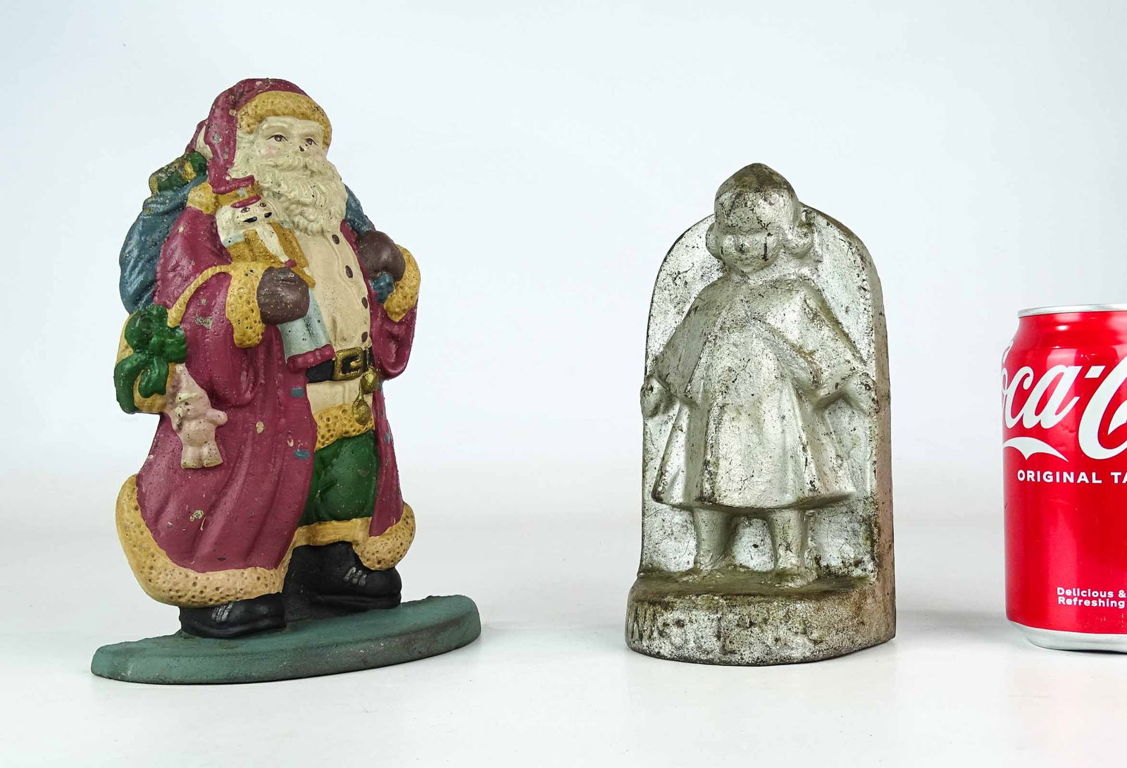 Doorstop Lot: Two doorstops including: Cast iron Santa Claus (8 3/8" Ht.), along with cast iron "Innocence" doorstop (7" Ht.).
