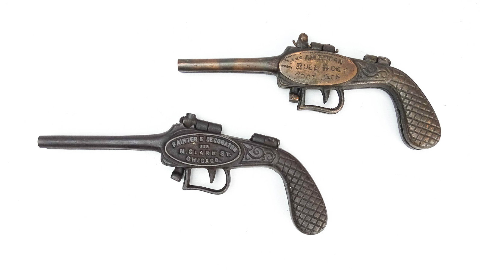 Pistol Bootjacks: Two rare cast iron bootjacks including "John Rhodes" (9" L.), and "The American Bull Dog" (8" L.).
