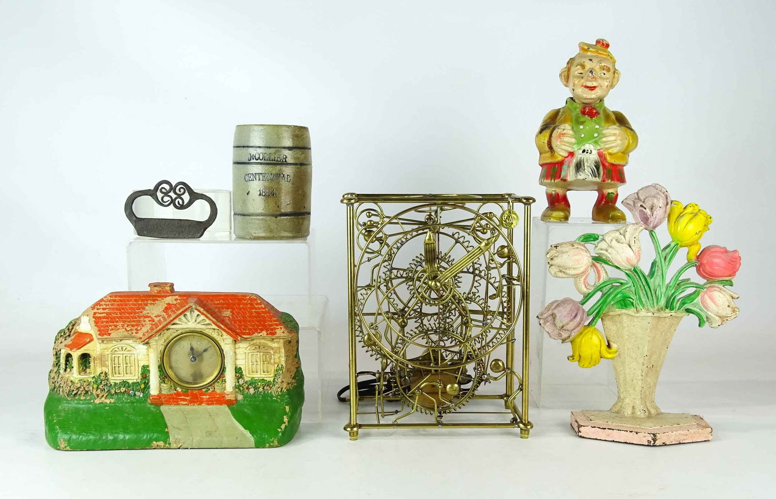 Misc. Lot: Lot including vintage "Bungalow" clock, stoneware beer mug marked "J. COLLIER CENTENNIAL 1884", cast iron floral doorstop (10" Ht.), match striker, metal nodder bank (8"Ht.). Brass skeleton clock. Bar