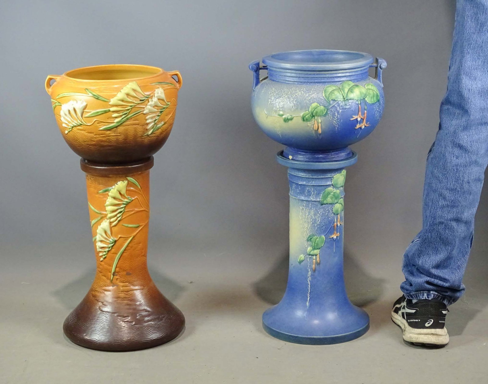 Roseville Lot: Lot (2) Roseville jardinieres and pedestals. One has small chip, one pedestal cracked. . Tallest 26" Ht.. Barbara Packer Collection.