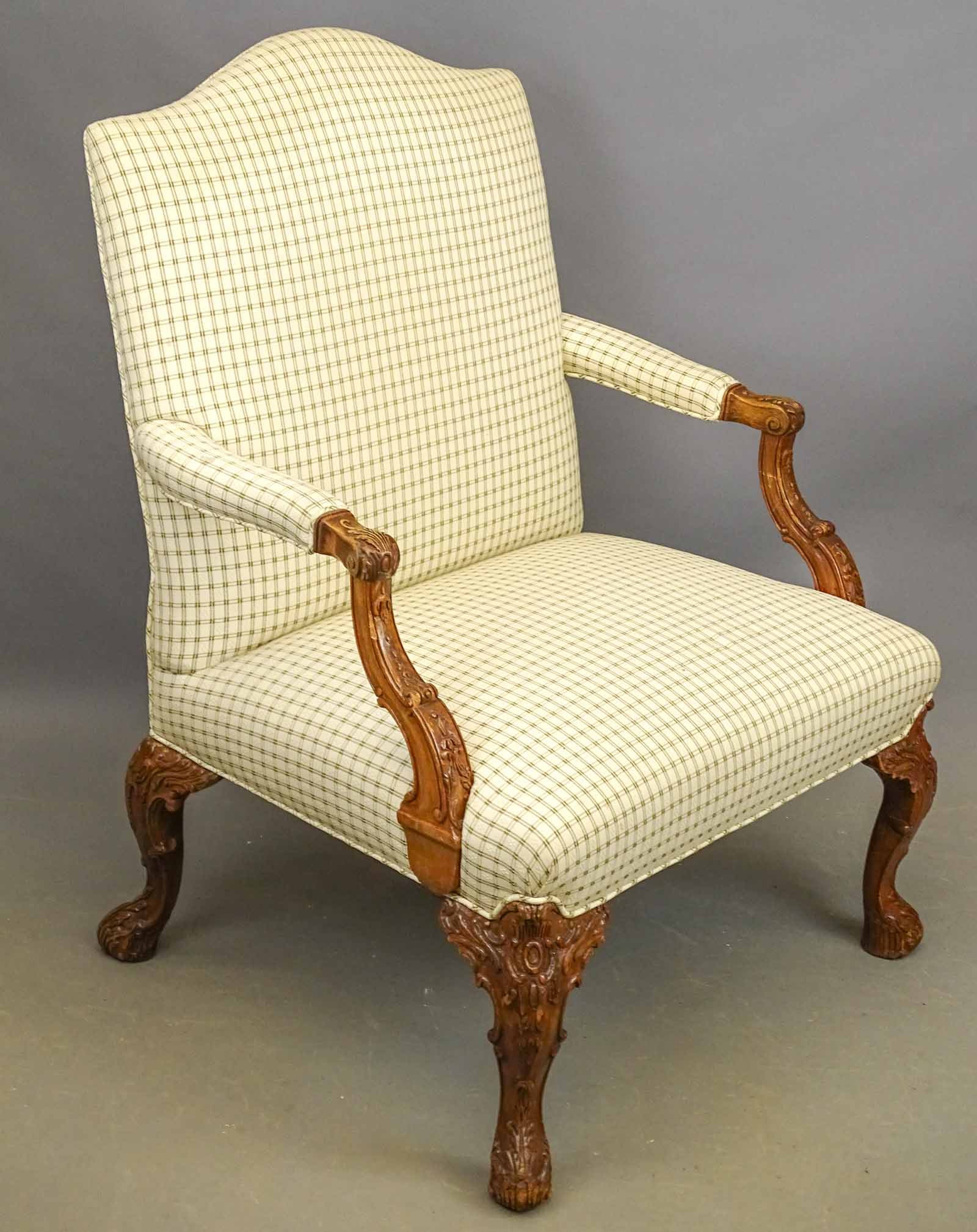 Carved Armchair: Chippendale style carved and upholstered armchair. 18" seat Ht., 41" overall Ht..
