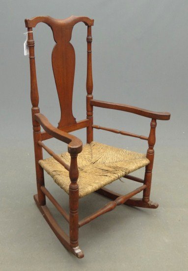 Queen Anne Rocking Chair: 18th c. Queen Anne rush seat armed rocking chair, unusual form having spindles below arms. 14" Seat Ht. 41" Overall Ht.