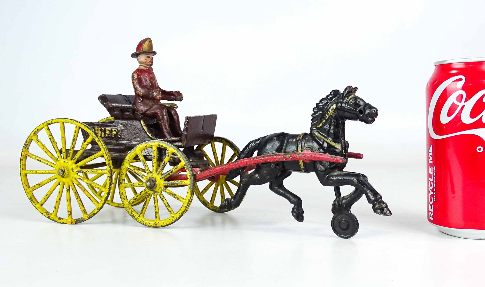 Cast Iron Horse and Buggy Toy: Early cast iron horse and buggy toy. "CHIEF" (with fireman rider). 12" L..