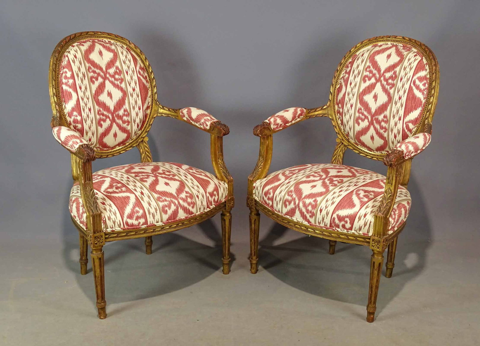 Pair of French Upholstered Chairs: Pair of French carved and upholstered armchairs. 18" seat Ht., 36 1/2" overall Ht..