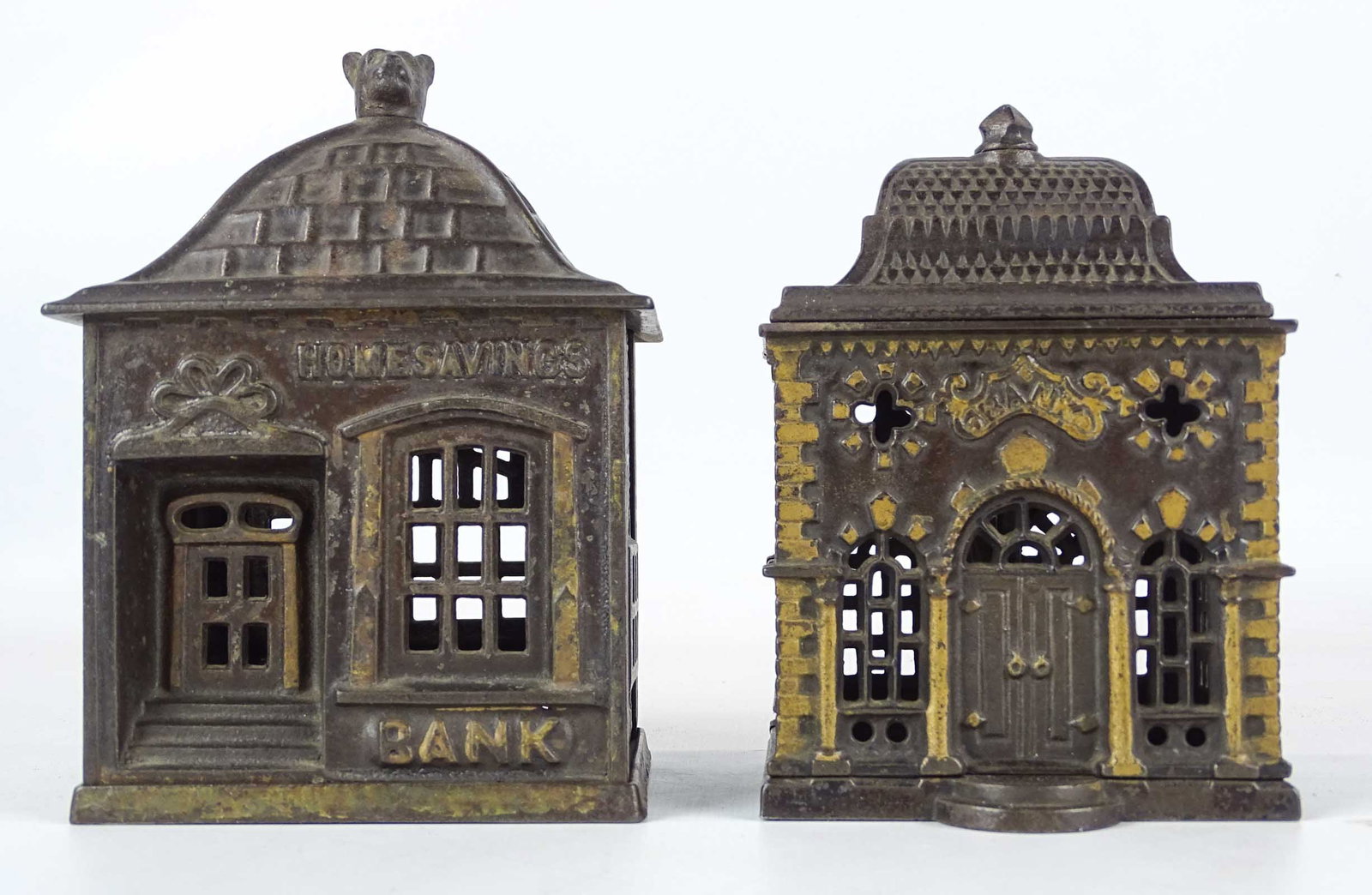 Bank Lot: Lot (2) 19th c. cast iron building banks. Includes "Roof Bank" (5 1/4" Ht., 1887, J.E. Stevens, #1122 Penny Bank Book), "Home Savings Bank" (with dog finial, 5 3/4" Ht., J.E. Stevens, #1237 Penny Bank
