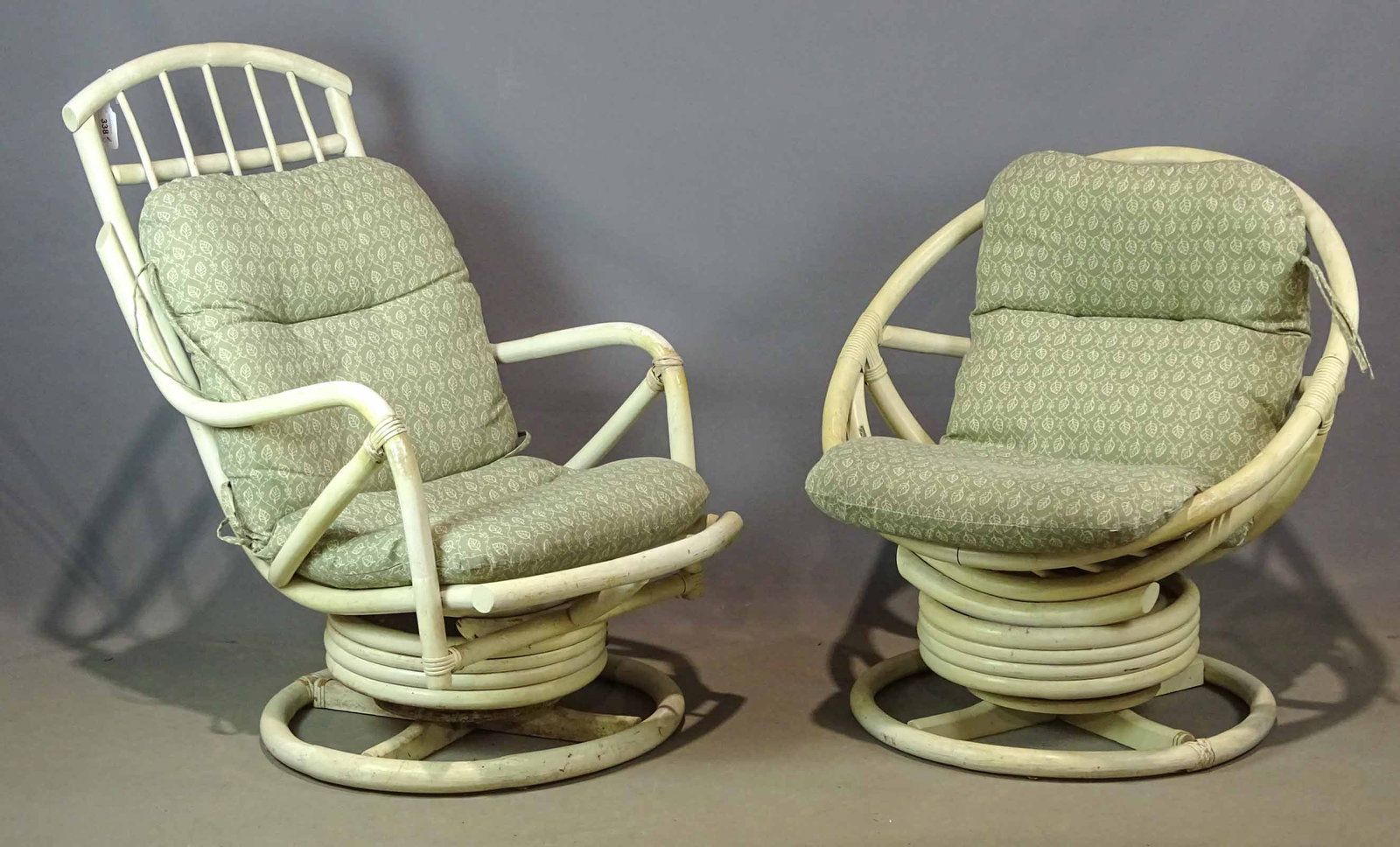 Pair Rattan Swivel Chairs: Pair of vintage swivel rattan chairs.