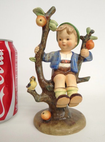 Hummel Figurine: Boy in the apple tree MJ Hummel figurine. Marked Germany. 6 3/4" Ht. Full bee., as found condition, arm repaired.