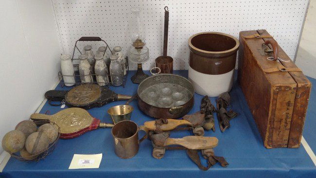 Misc. Lot: Misc. table lot including vintage suitcase, crock, early utensils, early skates, oil lamp, bellows, carnival knock down milk bottles etc.