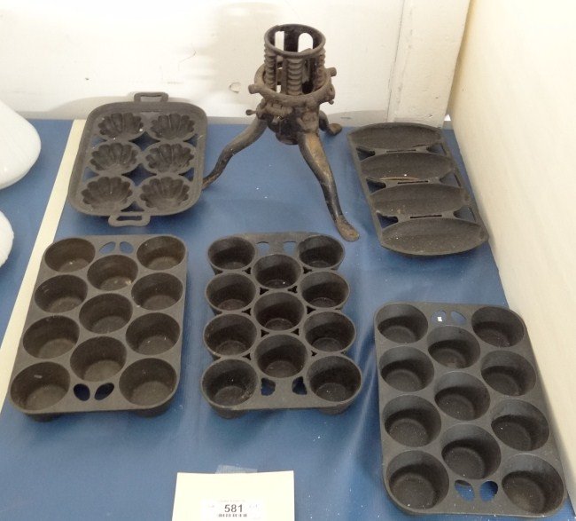 Iron Lot: Lot including early Christmas tree stand and five iron muffin pans.