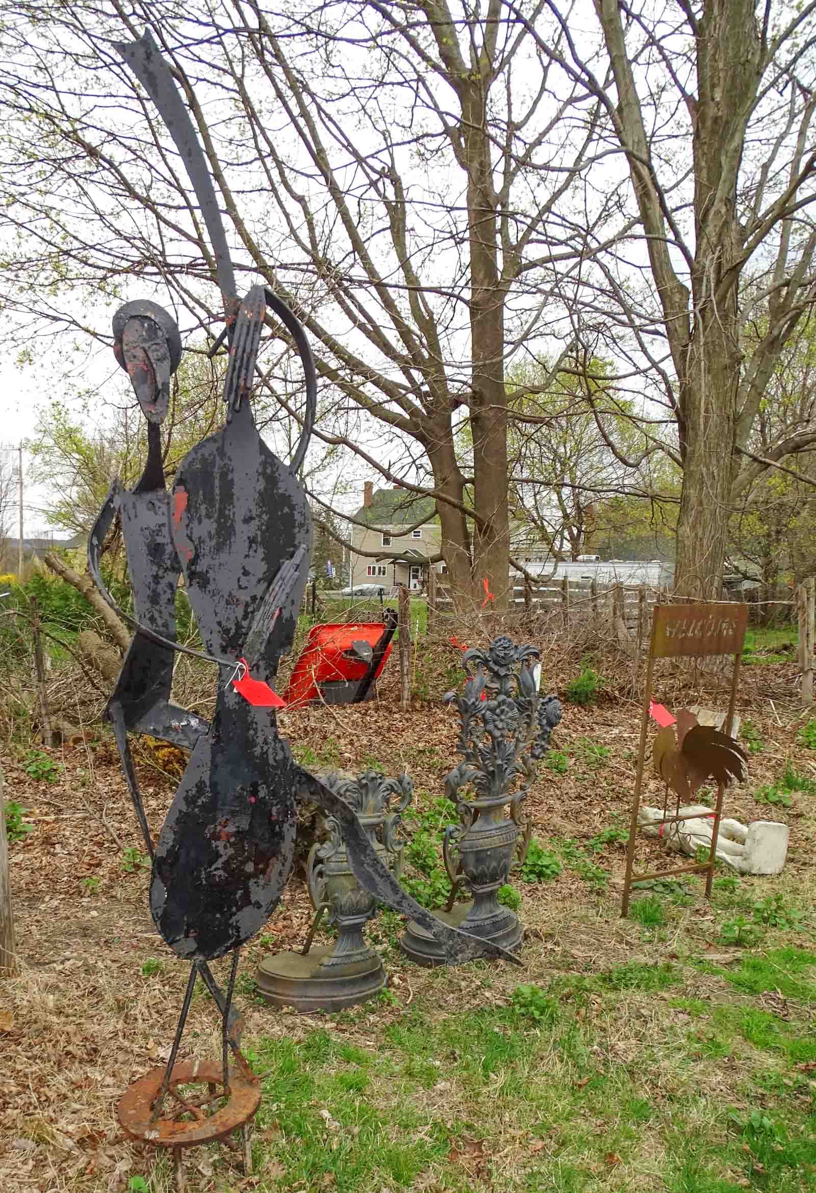 Metal Garden Sculpture: Metal garden sculpture of a dancer with bass guitar. 8' Ht.. Barbara Packer Collection.