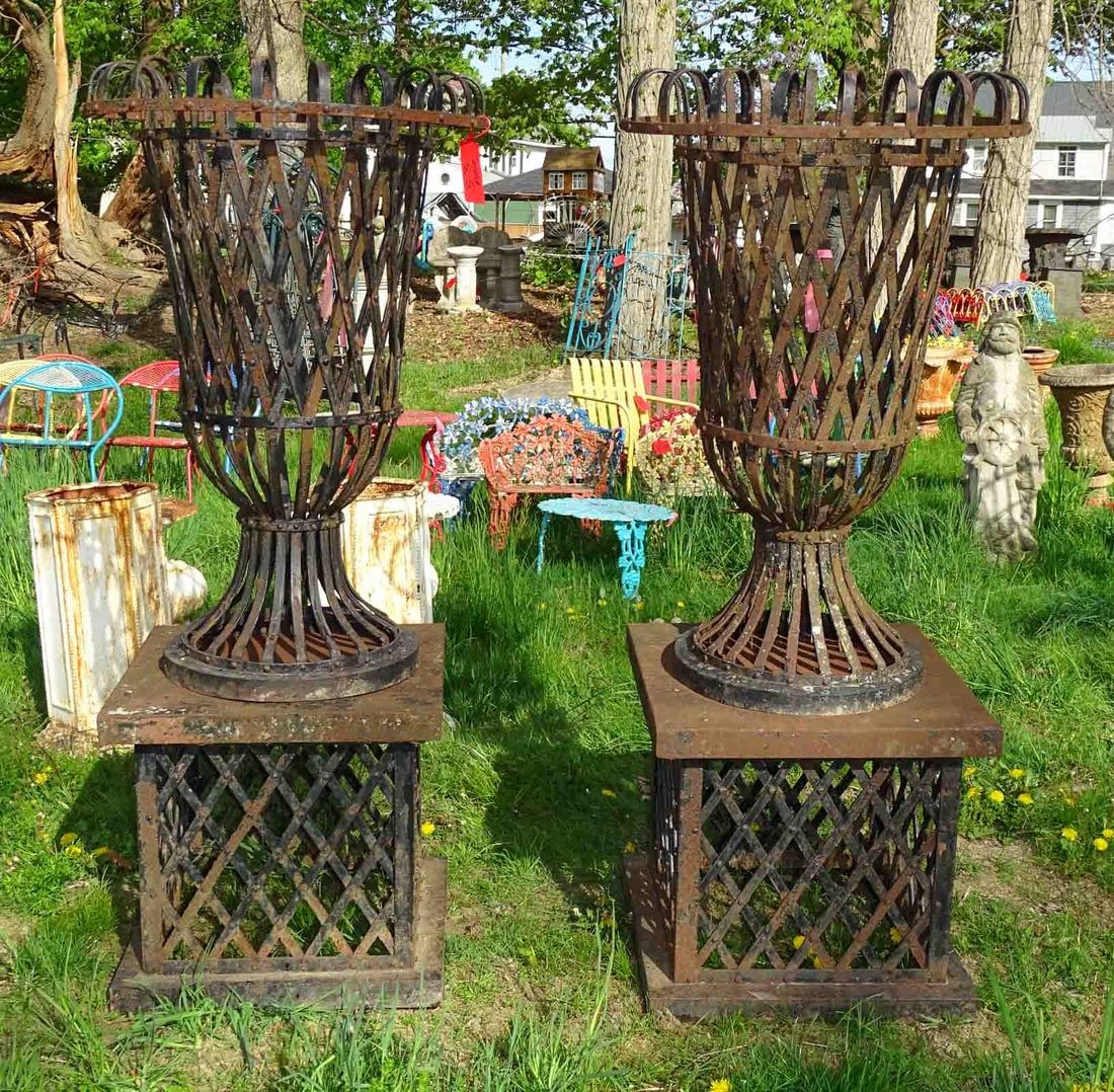 Pair of Urns: Pair of strap form urns on stands. 65" Ht.. Barbara Packer Collection.