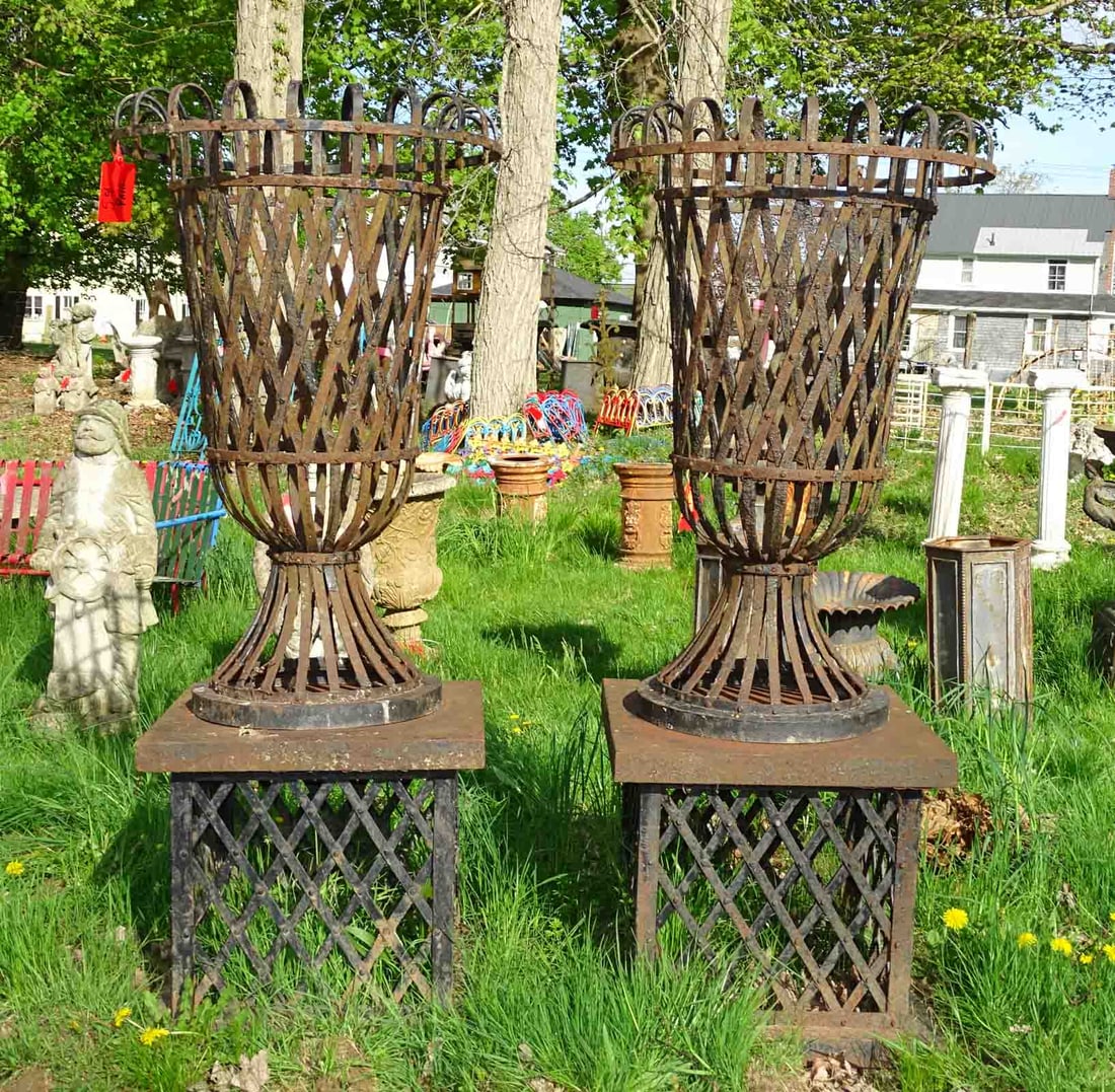 Pair of Urns: Pair of strap form urns on stands. 65" Ht.. Barbara Packer Collection.