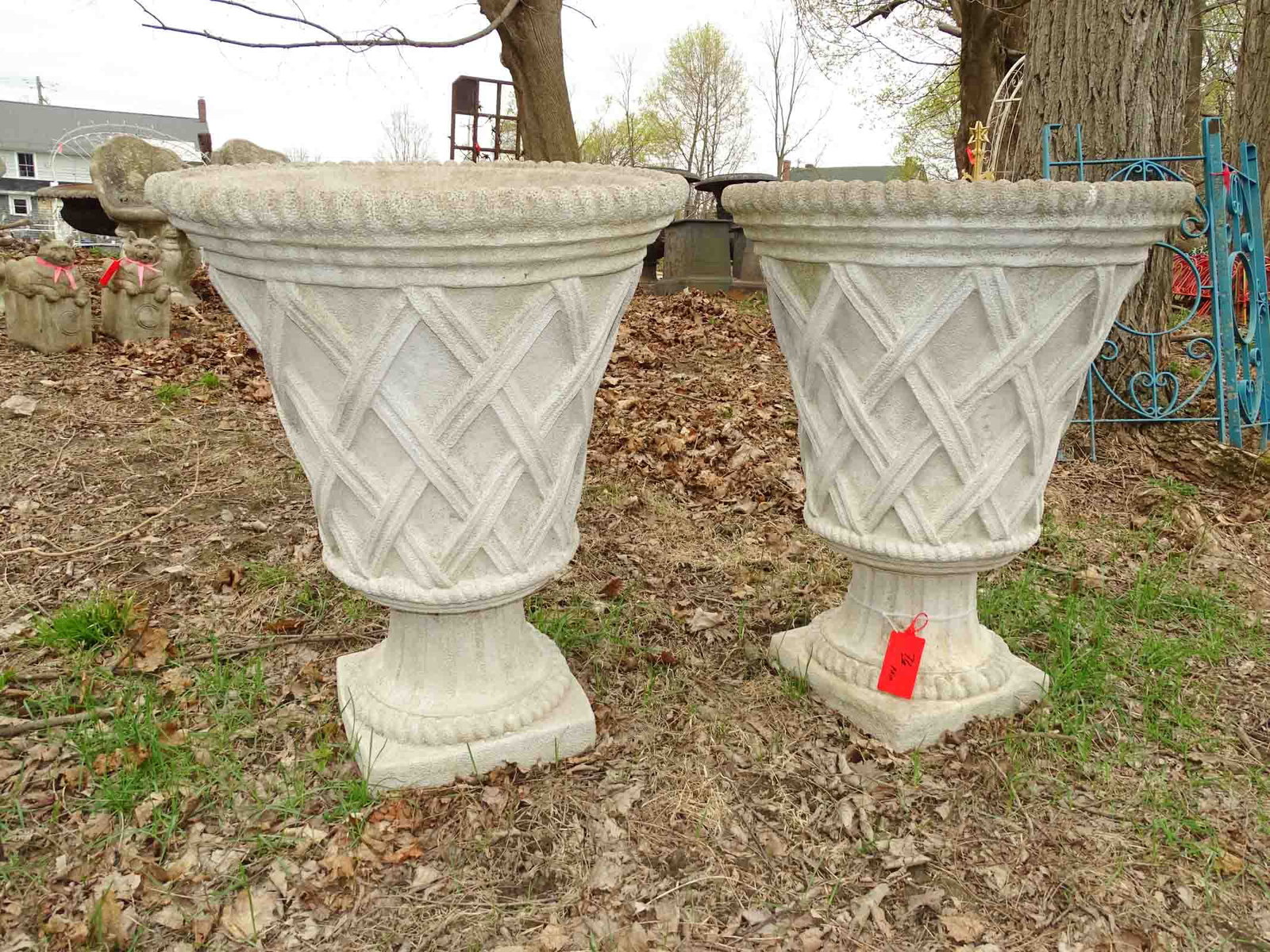 Pair of Urns: Pair of cast stone urns. 36" Ht. x 29" Dia.. Barbara Packer Collection.