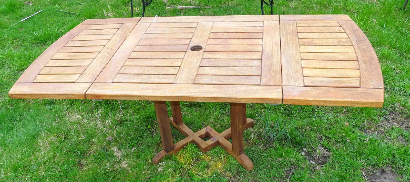 Teak Table: Teak table with extension leaves. 35 1/2" Sq. with leaves 72" L x 28" Ht..