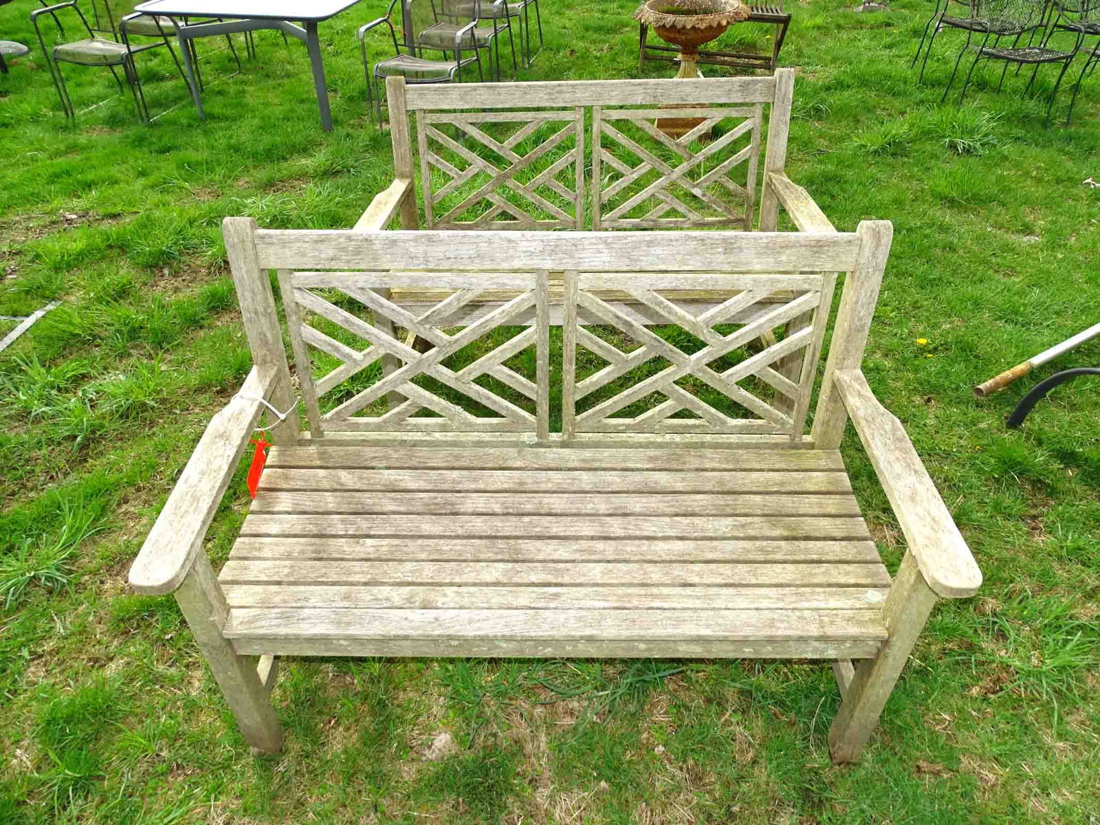 Pair of Teak Settees: Pair of teak settees with Asian motif backs 49" W. x 34" Ht..