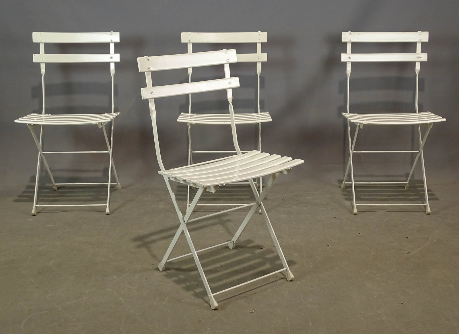 Folding Chairs: Set of four slatted folding chairs.