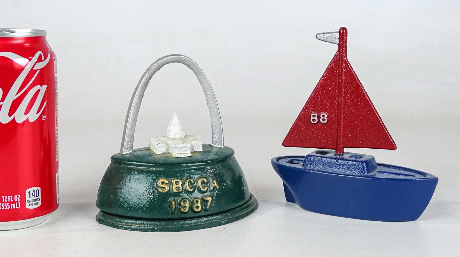 Bank Lot: Lot (2) cast iron banks including Souvenir Bank for the Still Bank Collection Club 1988, 4 3/4" Ht. and Souvenir bank for the Still Bank Collector Club 1866,St. Louis Arch, 4 1/4" Ht..