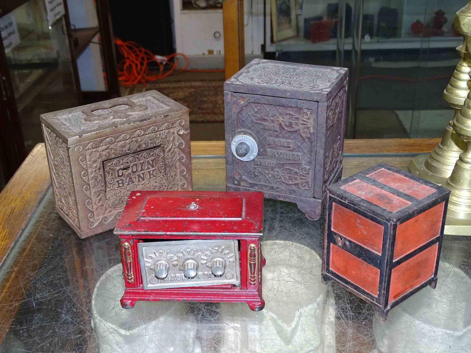 Bank Lot: Lot (4) 19th c. cast iron safe banks. Tallest 5 1/2" Ht..