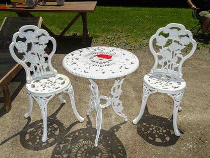 Cast Iron Patio Set: Cast iron patio set (3) pieces in rose pattern. Table 23" Dia. x 26 1/2" Ht., pair of chairs 16" seat Ht. x 33 1/4" Ht..