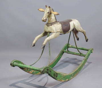 19th c. Child's Rocking Horse: 19th c. painted wooden rocking horse. Great form. 40" x 14" x 29" Ht.. Cast head.