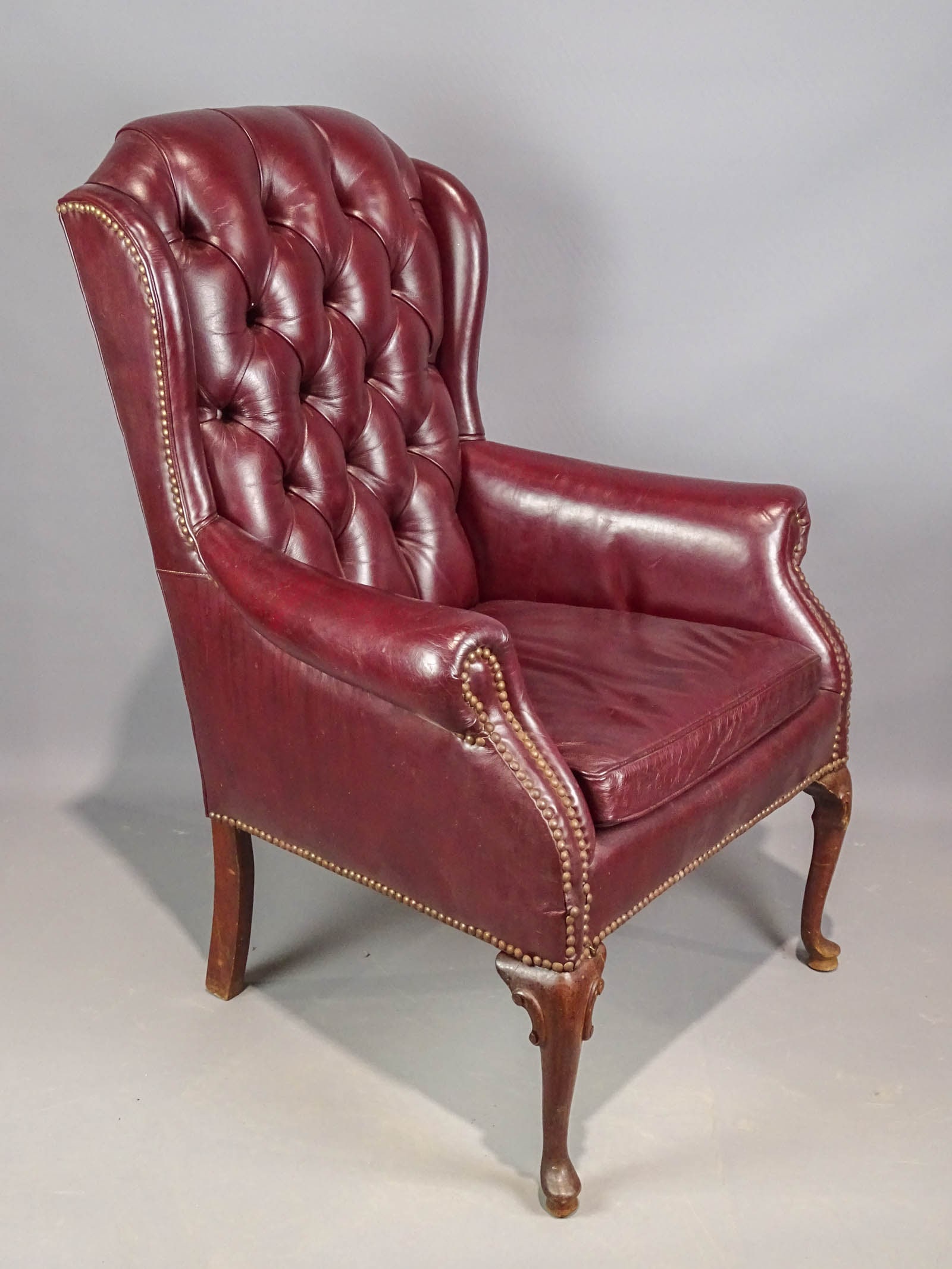 Leather Wing Chair: Leather tufted wing chair. 20" seat Ht., 42" overall Ht..