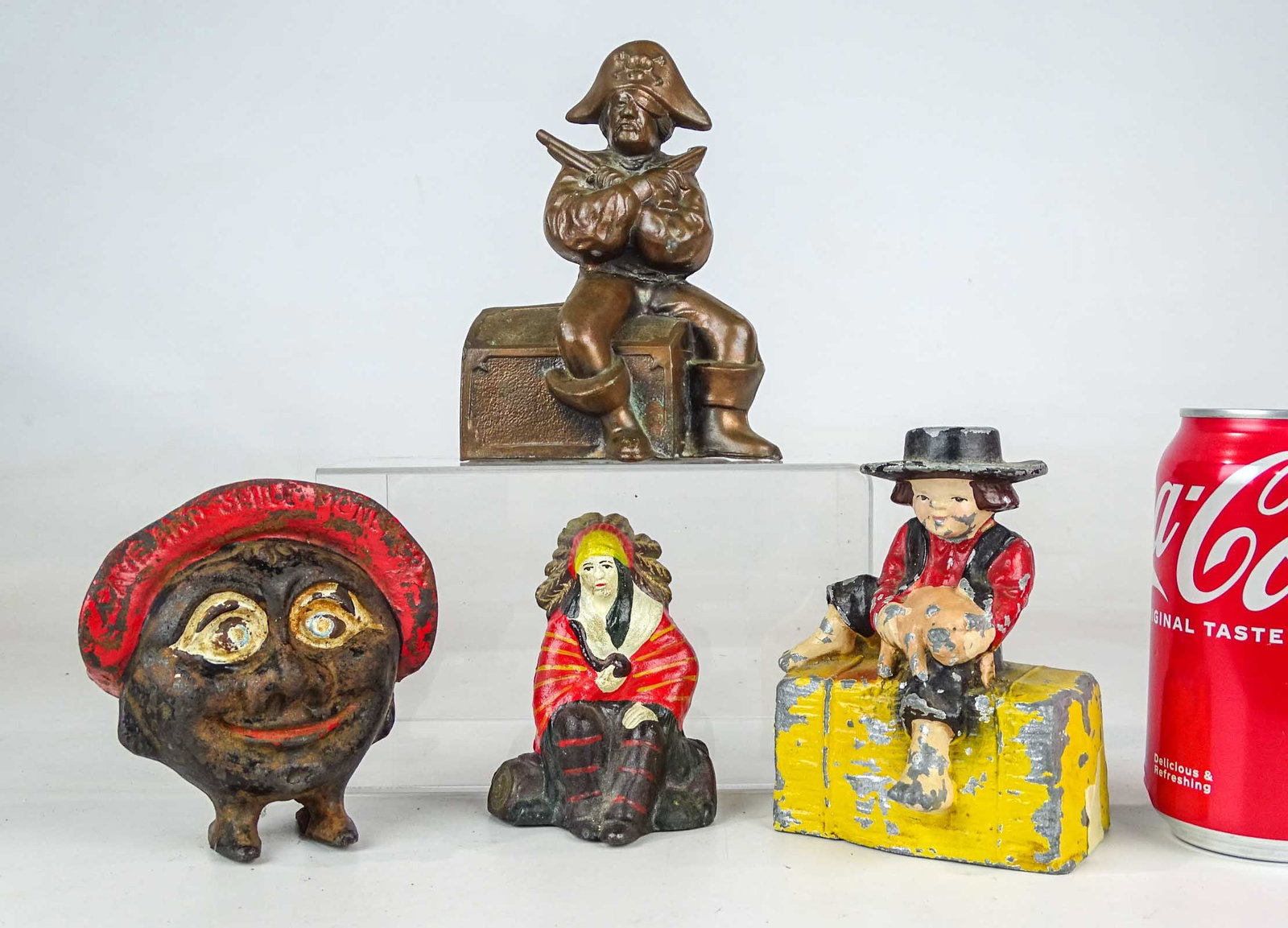 Bank Lot: Lot (3) cast metal banks including Amish man with pig, American Indian, "SAVE AND SMILE", Pirate. Tallest 6" Ht..